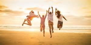 happy people jumping into sunrise